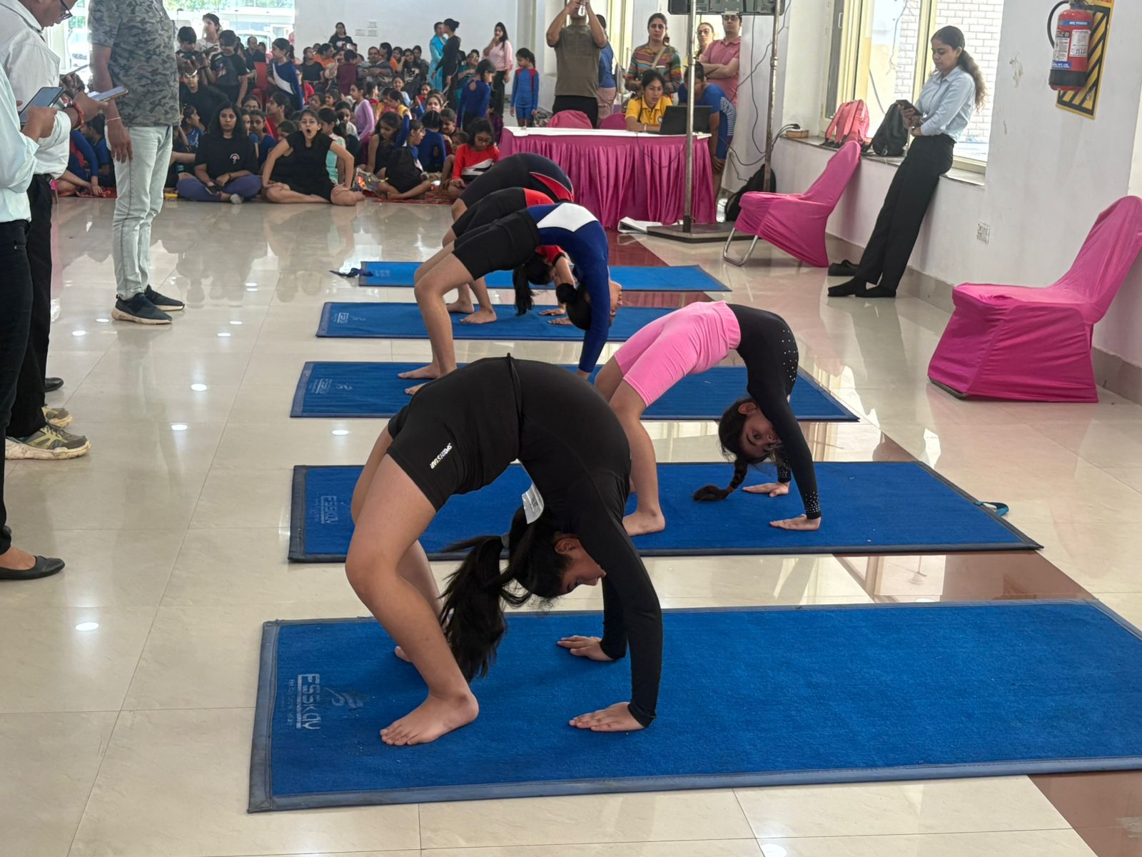 Attmashuddhi students showcasing flexibility and balance in a yoga practice event